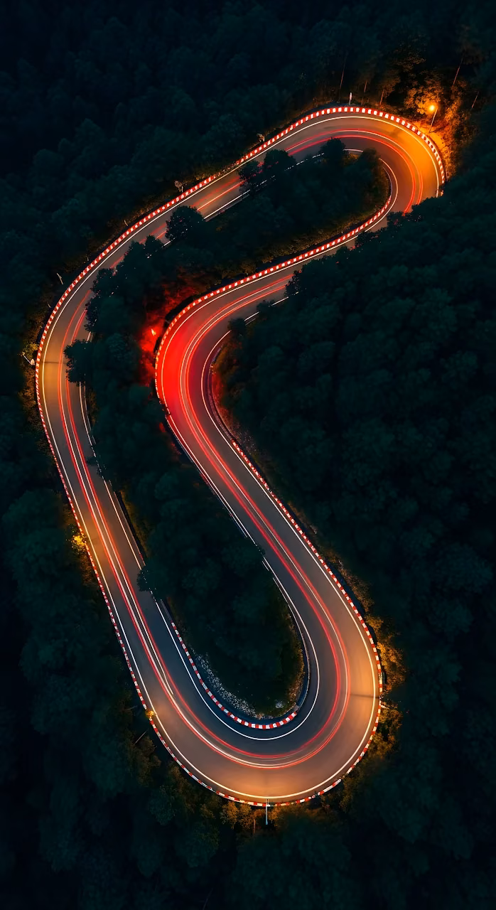Aerial Night Shot of Serpentine Road with Car Light Trails - Free Mobile AMOLED Wallpaper Background