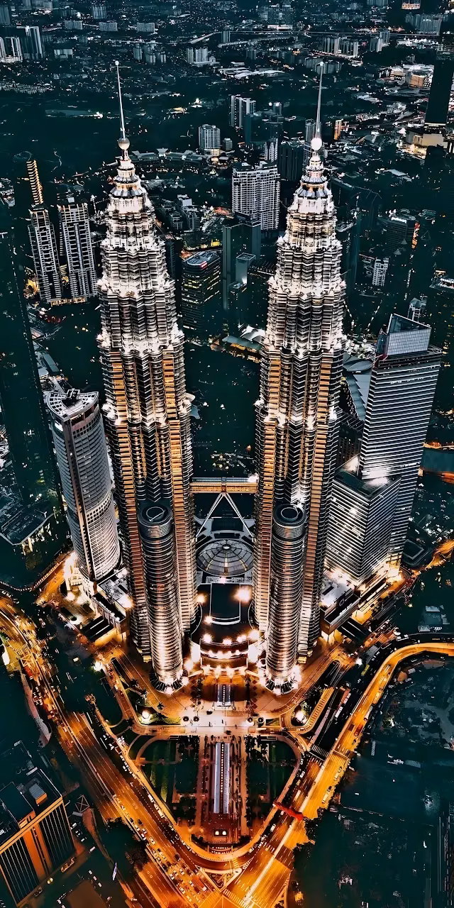 Download Aerial Night View of Illuminated Petronas Twin Towers Wallpaper in Mobile HD Aerial Night View of Illuminated Petronas Twin Towers - Free Mobile AMOLED Wallpaper Background