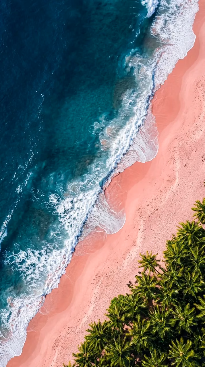 Aerial Top Down Shot of Ocean Waves Crashing on Pink Sand Beach - Free Mobile AMOLED Wallpaper Background