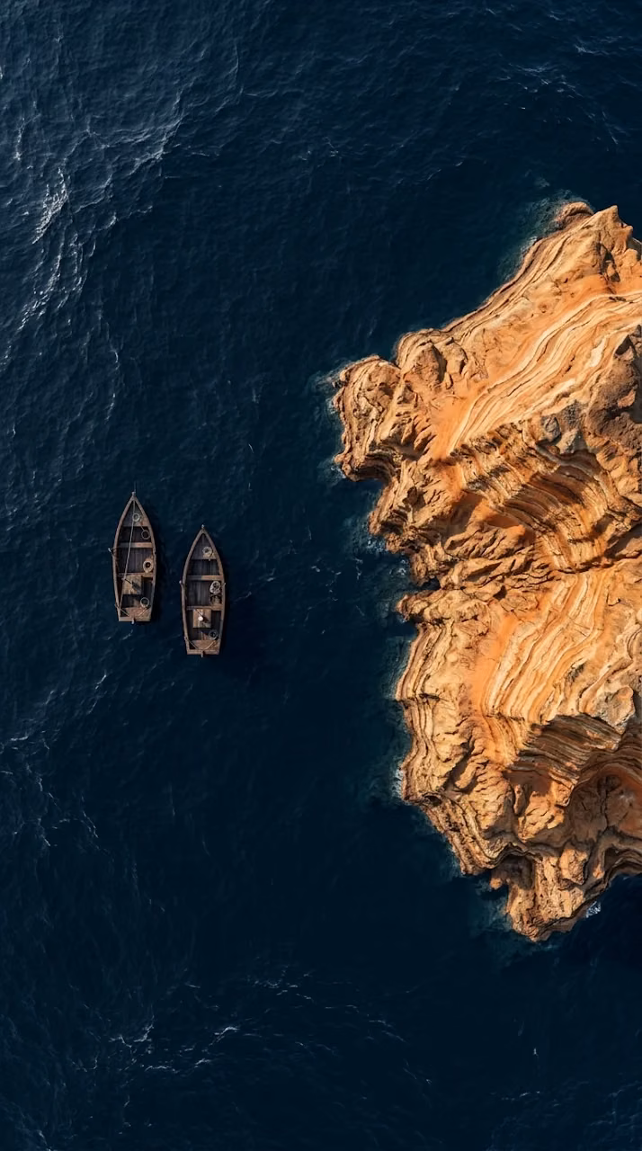 Download Aerial Top-Down View of Two Boats Near Layered Rock Formations Wallpaper in Mobile HD Aerial Top-Down View of Two Boats Near Layered Rock Formations - Free Mobile AMOLED Wallpaper Background