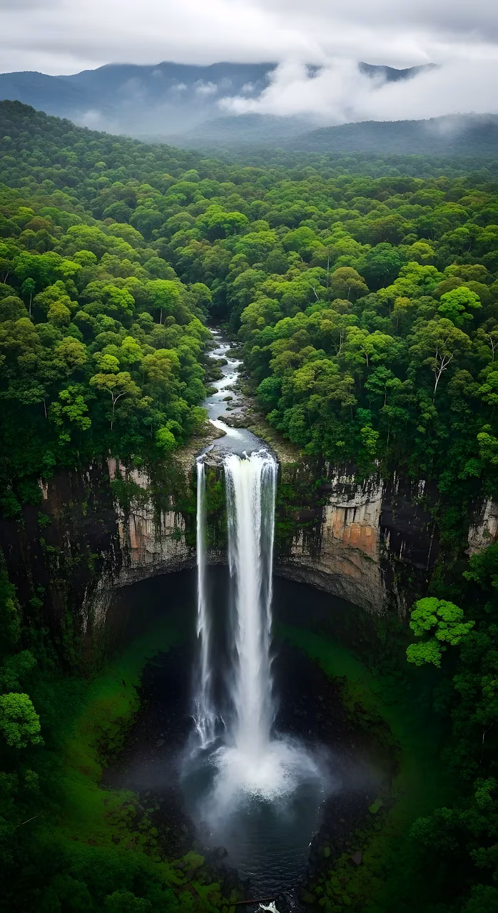 Aerial View of Majestic Waterfall in Lush Green Rainforest - Free Mobile AMOLED Wallpaper Background