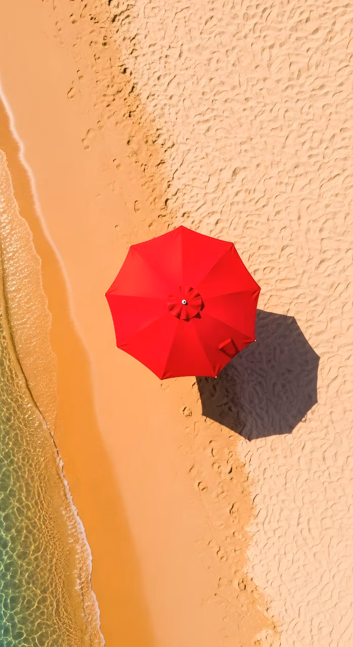 Aerial View Red Beach Umbrella Golden Sand Shoreline - Free Mobile AMOLED Wallpaper Background