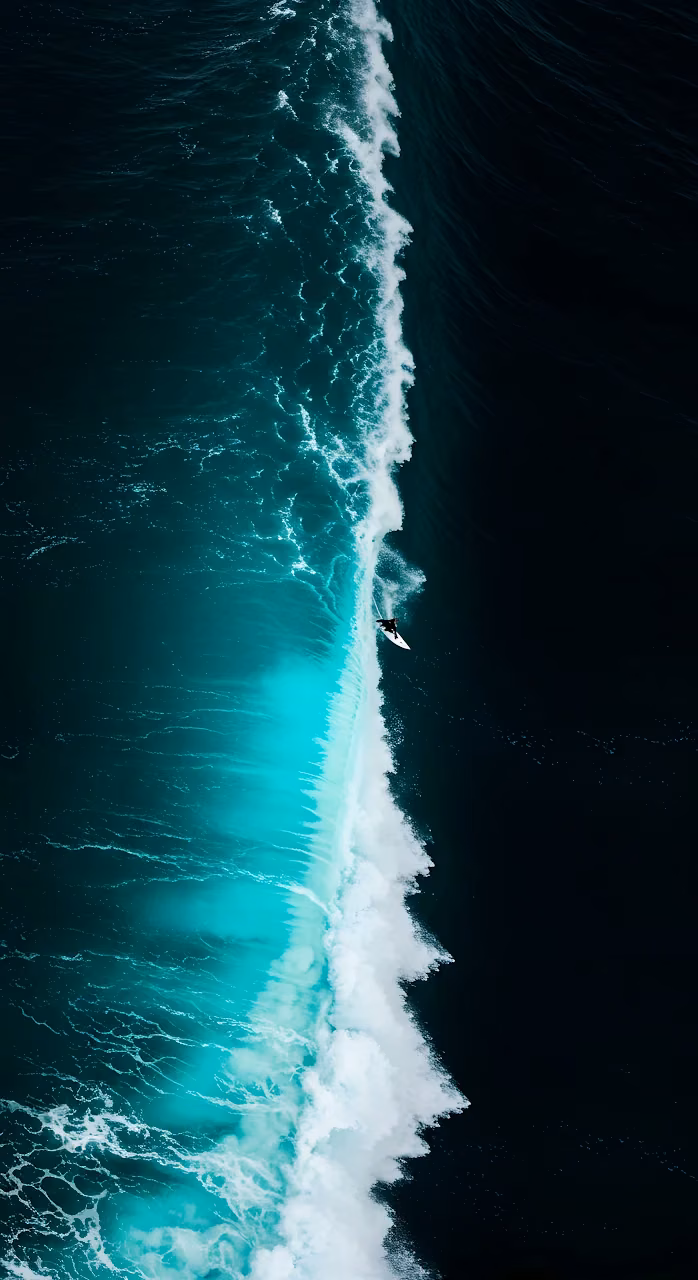 Download Aerial View of Surfer Riding Massive Teal Ocean Wave Wallpaper in Mobile HD Aerial View of Surfer Riding Massive Teal Ocean Wave - Free Mobile AMOLED Wallpaper Background