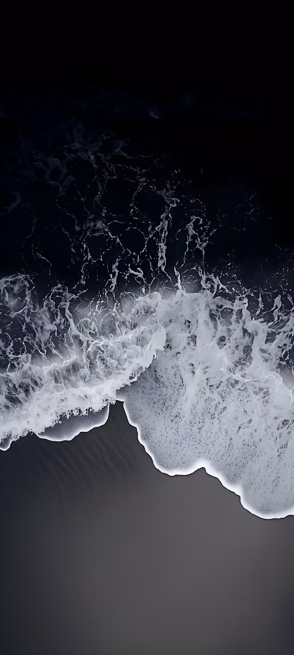 Aerial View of White Ocean Foam on Dark Black Sand Beach - Free Mobile AMOLED Wallpaper Background