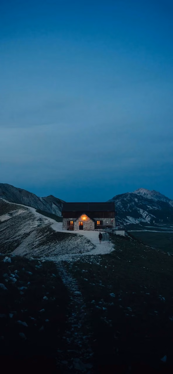 Alpine Refuge Glowing at Twilight in Dolomite Mountains - Free 4K Desktop Wallpaper Background