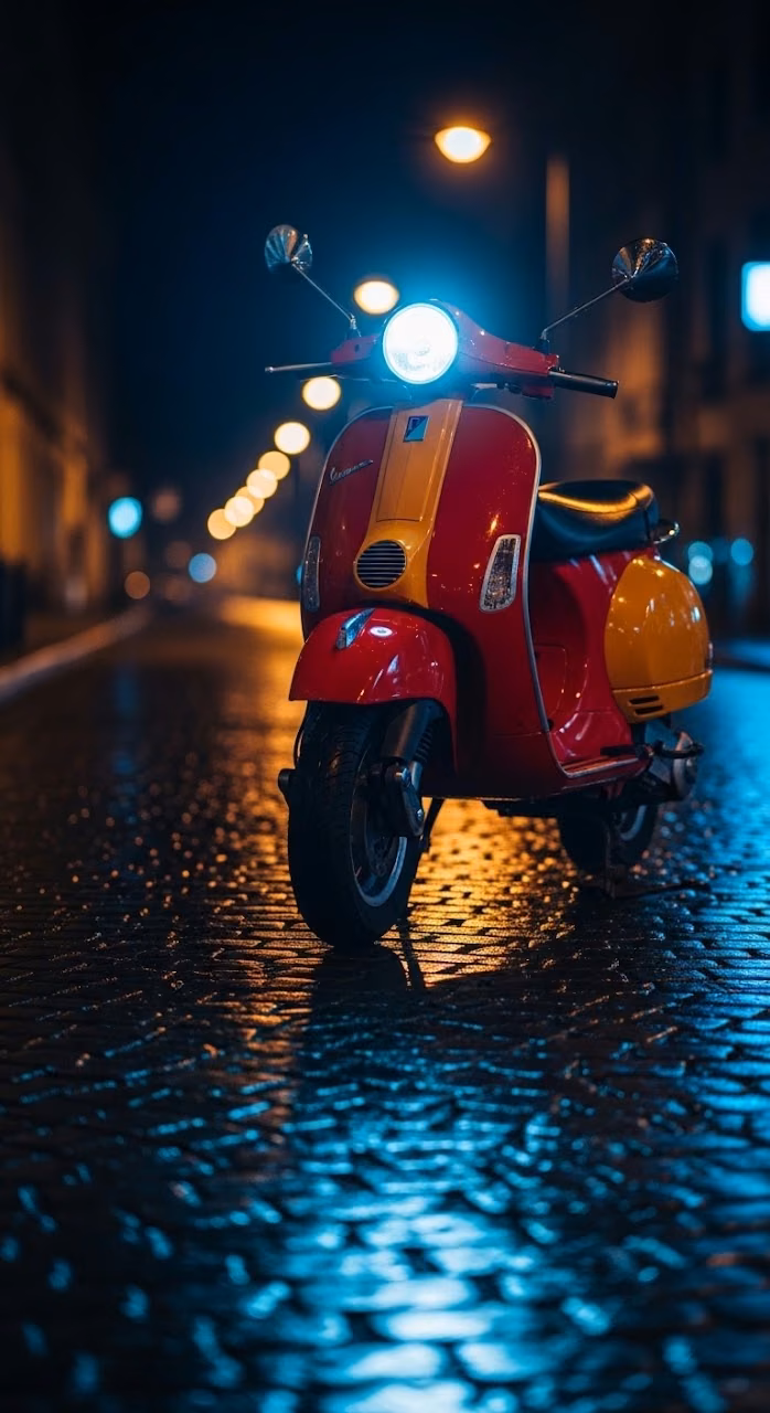 Close-up of a Vintage Red and Yellow Scooter on a Wet, Dark Urban Street at Night - Free Mobile AMOLED Wallpaper Background