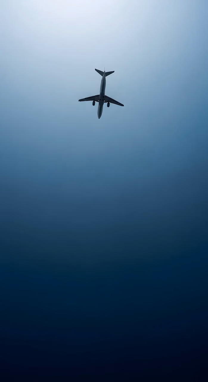 Commercial Jet Silhouette Against Deep Blue Gradient Sky - Free Mobile AMOLED Wallpaper Background