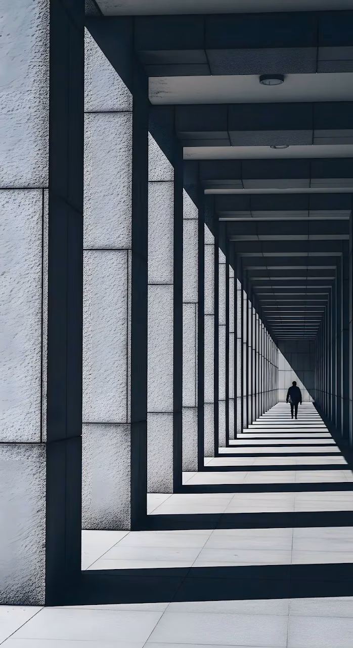 Dramatic Architectural Corridor with Single Figure - Free Mobile AMOLED Wallpaper Background