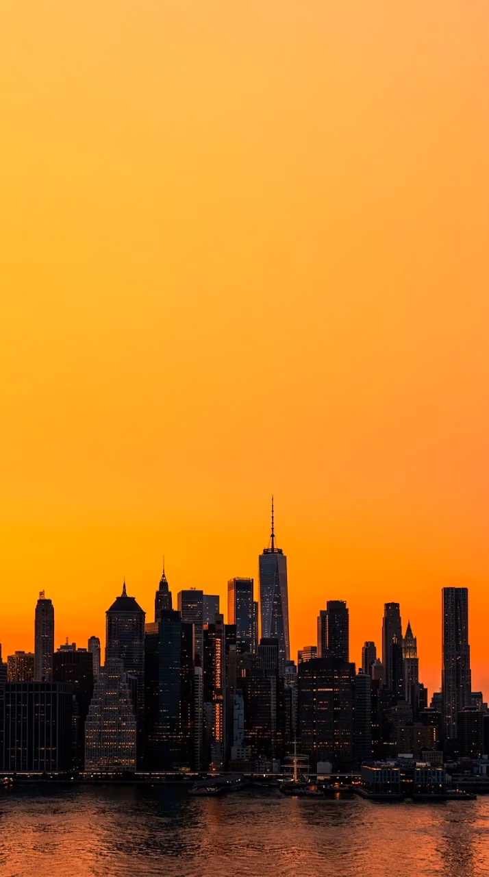 Dramatic Orange Sunset Silhouette over New York City Skyline - Free Mobile AMOLED Wallpaper Background
