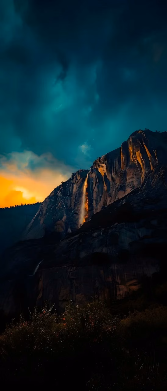 Firefall Illusion on Dark Granite Cliff at Sunset - Free Mobile AMOLED Wallpaper Background