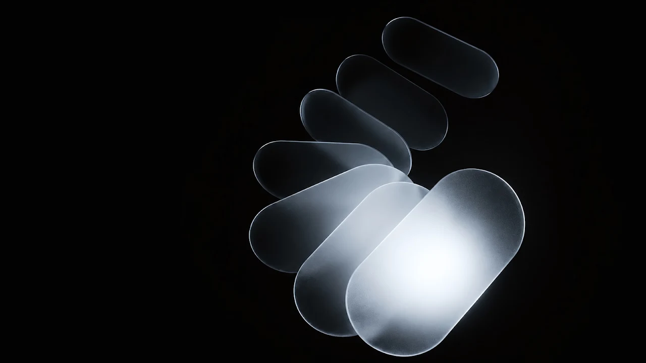 Download Frosted Glass Spiral Minimalist Dark 4K Wallpaper in 4K UHD Overlapping frosted translucent glass oval shapes arranged in a spiral curve glowing softly on a black background.