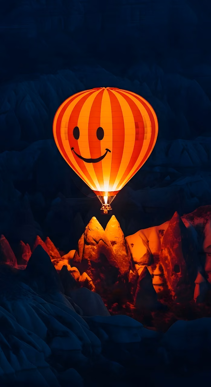 Glowing Smiley Hot Air Balloon Over Cappadocia at Night - Free Mobile AMOLED Wallpaper Background
