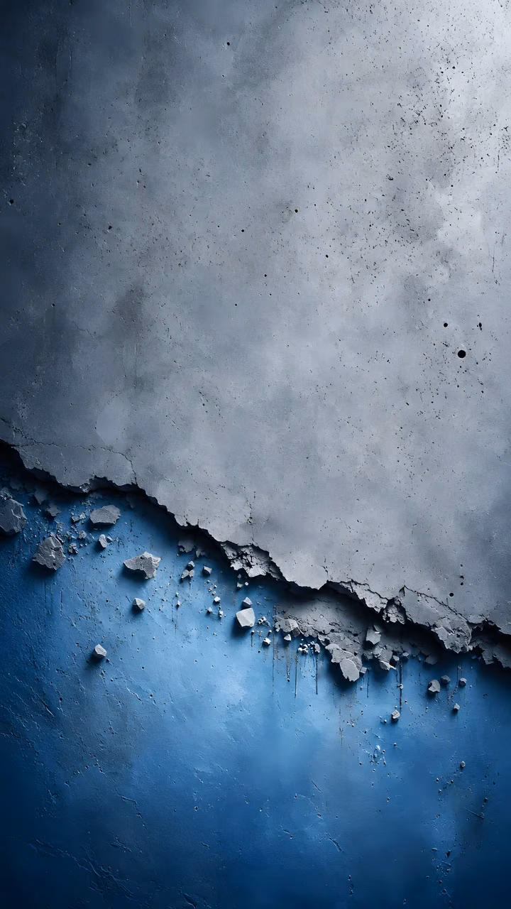 Download Grey cracked concrete surface peeling over blue textured layer Wallpaper in Mobile HD Close-up of a broken grey concrete wall peeling away diagonally to reveal a textured bright blue layer beneath.