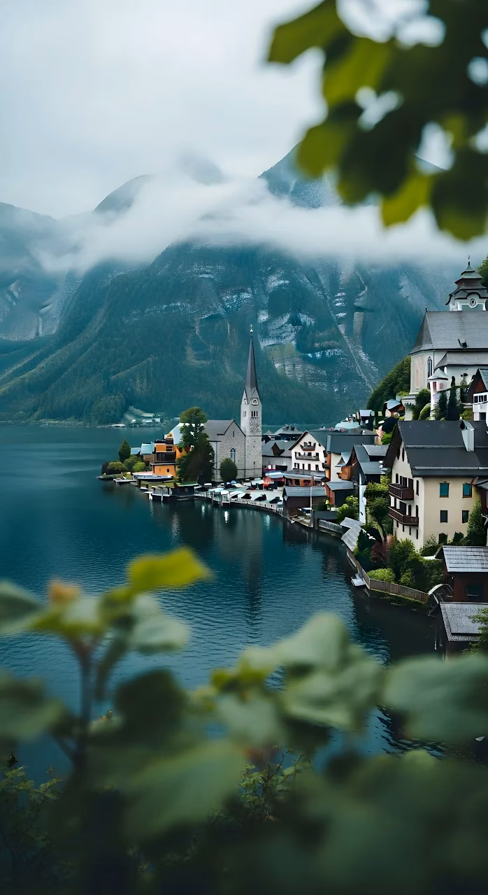 Hallstatt Village on Lake Shore Framed by Misty Mountains - Free Mobile AMOLED Wallpaper Background