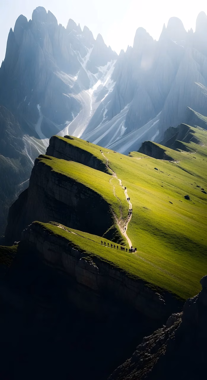 Hikers Ascending Green Alpine Ridge with Jagged Mountains - Free Mobile AMOLED Wallpaper Background
