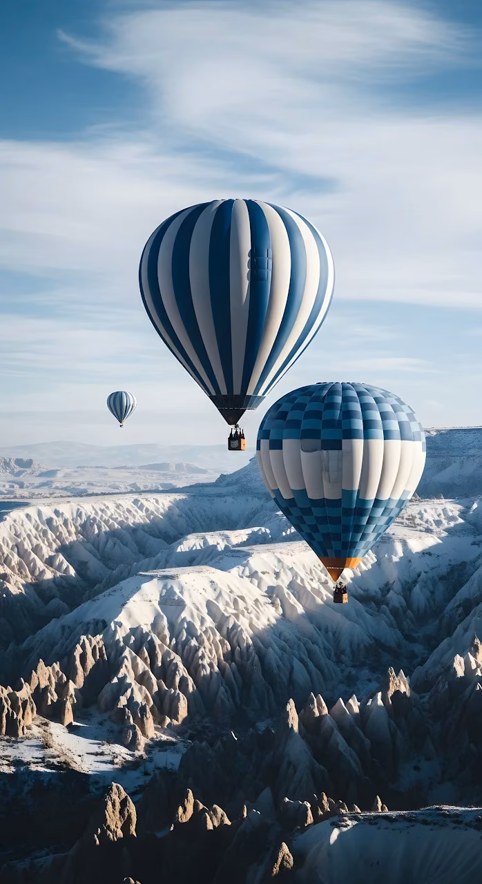 Hot Air Balloons Flying Over Snowy Cappadocia Landscape - Free Mobile AMOLED Wallpaper Background