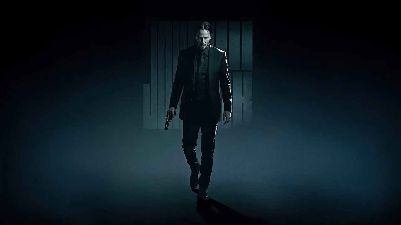 Download John Wick Shadow Walk 4K Wallpaper in 4K UHD John Wick walking forward in a dark suit holding a handgun in his right hand.