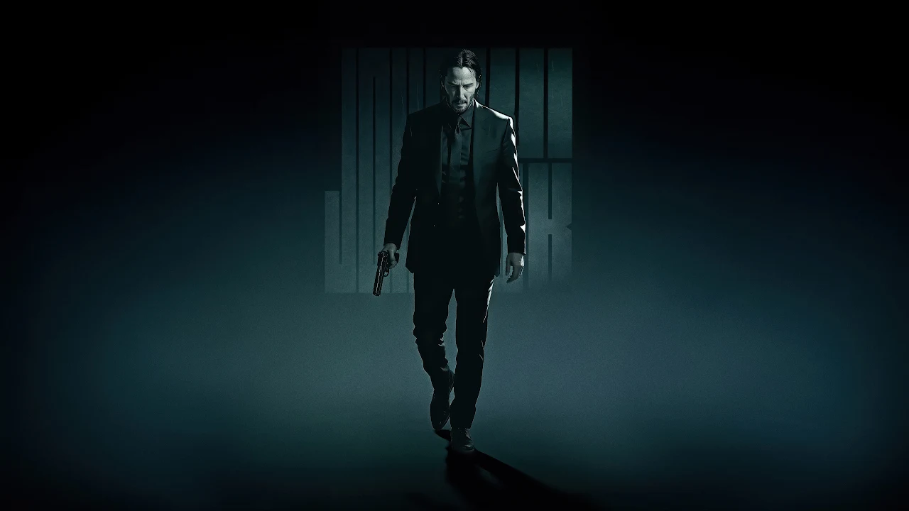 Download John Wick Shadow Walk 4K Wallpaper in 4K UHD John Wick walking forward in a dark suit holding a handgun in his right hand.