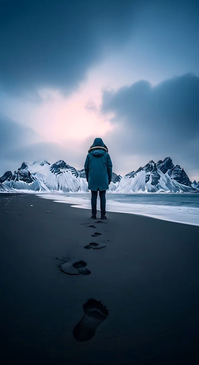 Download Lone Figure on Black Sand Beach with Snowy Vestrahorn Mountains Wallpaper in Mobile HD Lone Figure on Black Sand Beach with Snowy Vestrahorn Mountains - Free Mobile AMOLED Wallpaper Background