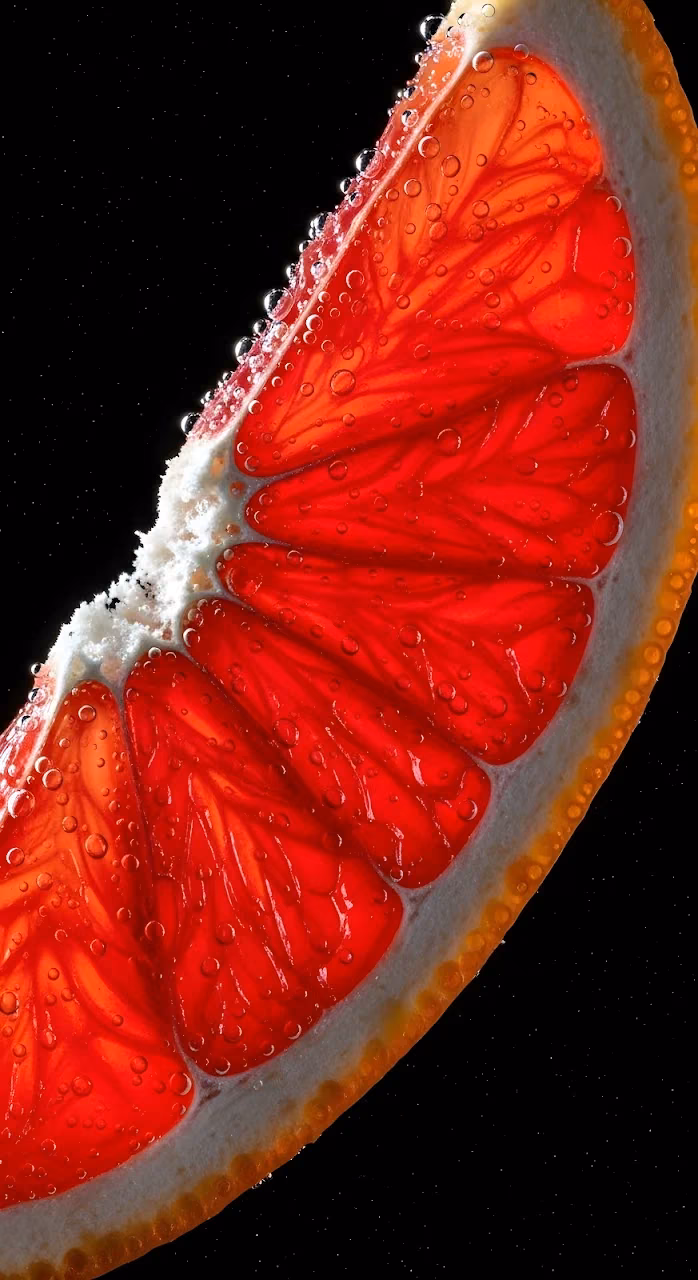 Download Macro View of Ruby Red Grapefruit Slice with Carbonation Wallpaper in Mobile HD Macro View of Ruby Red Grapefruit Slice with Carbonation - Free Mobile AMOLED Wallpaper Background