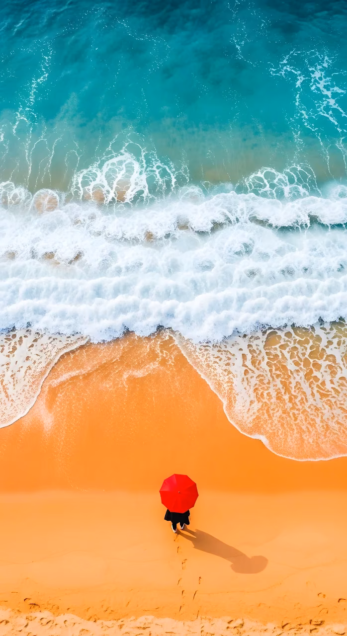 Minimalist Aerial View of Red Umbrella on Orange Beach - Free Mobile AMOLED Wallpaper Background