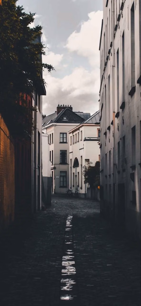 Download Moody Cobblestone Alleyway Between Tall European Buildings Wallpaper in 4K UHD Moody Cobblestone Alleyway Between Tall European Buildings - Free 4K Desktop Wallpaper Background