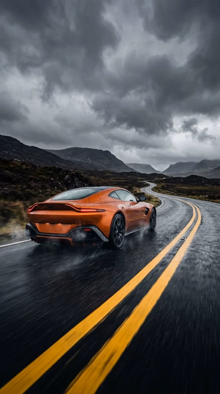 Orange High-Performance Sports Car on Dark Asphalt Road Under Stormy Clouds - Free Mobile AMOLED Wallpaper Background