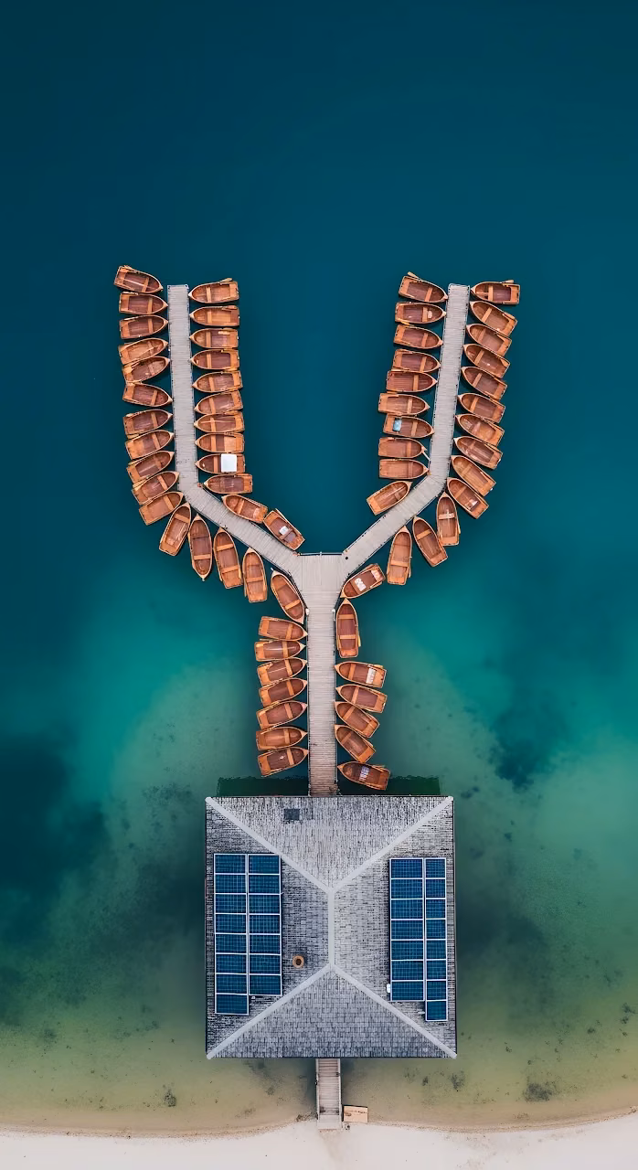 Overhead View of Wooden Boats Docked at Lago di Braies - Free Mobile AMOLED Wallpaper Background