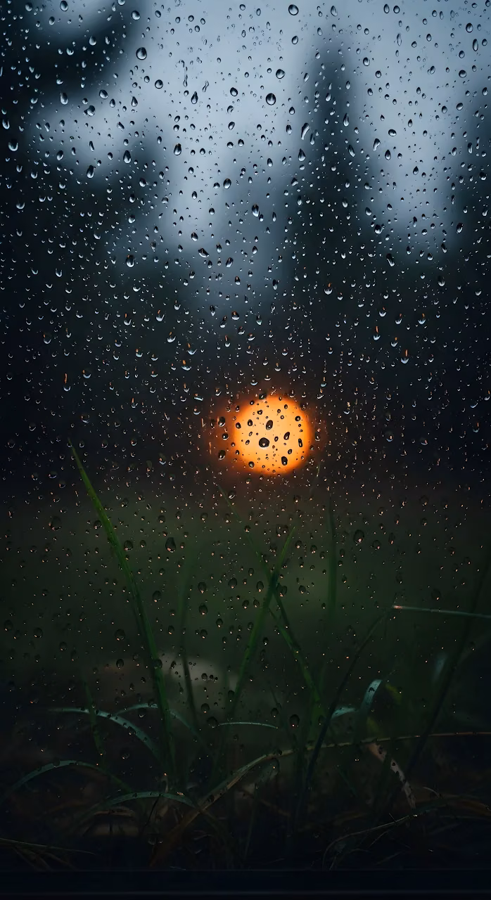 Raindrops on Window Glass with Orange Light Bokeh - Free Mobile AMOLED Wallpaper Background