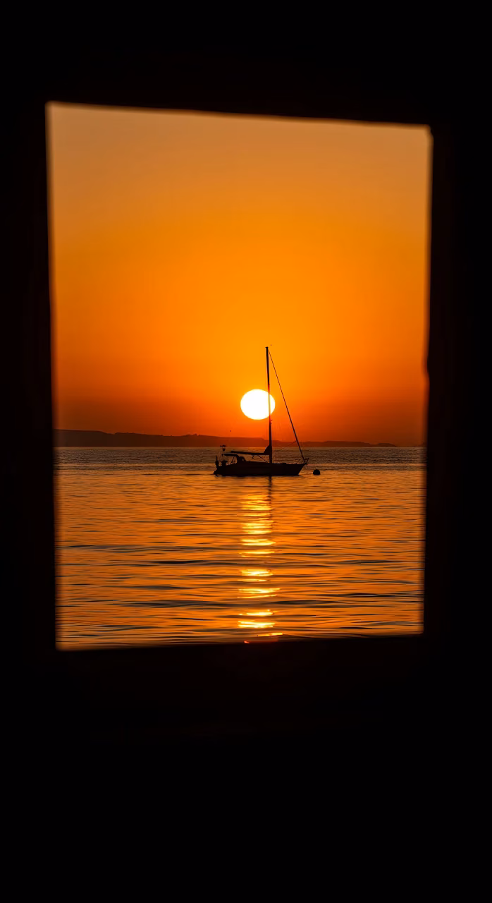 Download Sailboat Silhouette Framed by Intense Orange Sunset Wallpaper in Mobile HD Sailboat Silhouette Framed by Intense Orange Sunset - Free Mobile AMOLED Wallpaper Background