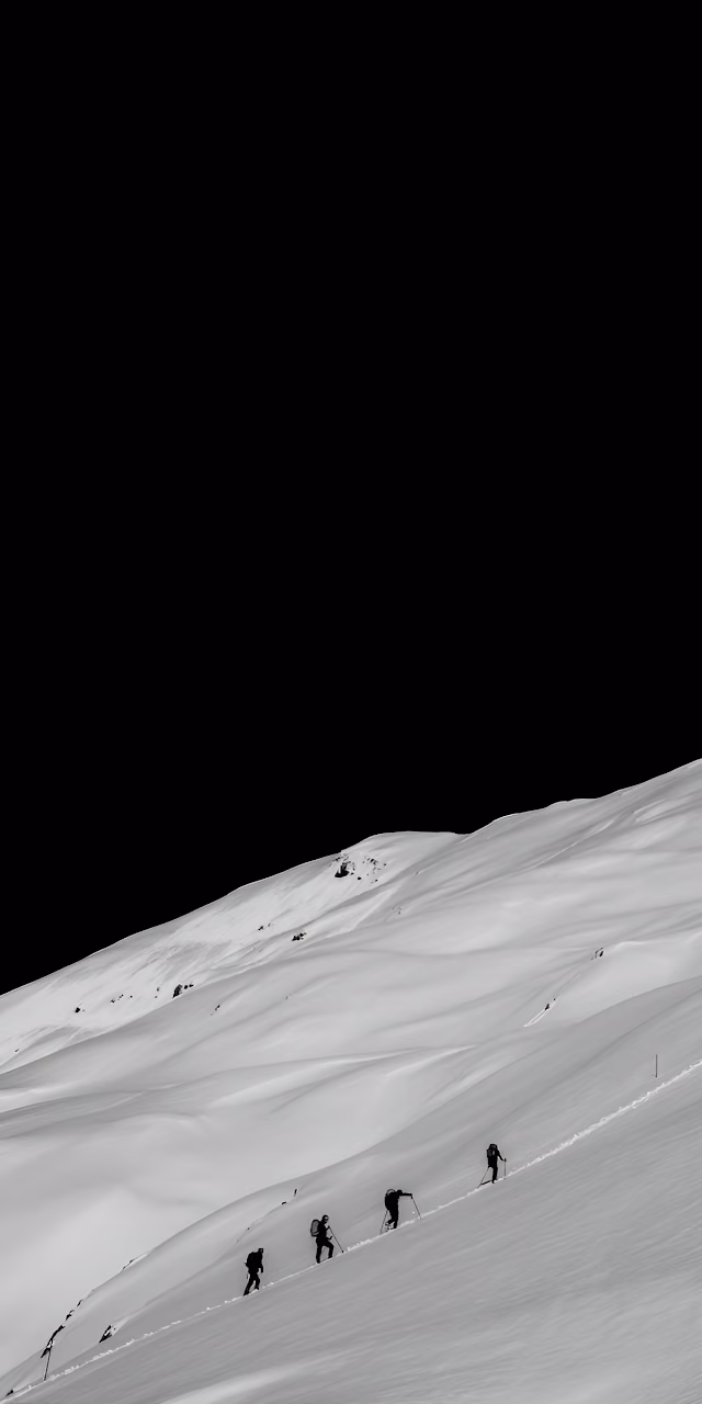 Silhouettes of Mountaineers Ascending Snowy Slope - Free Mobile AMOLED Wallpaper Background