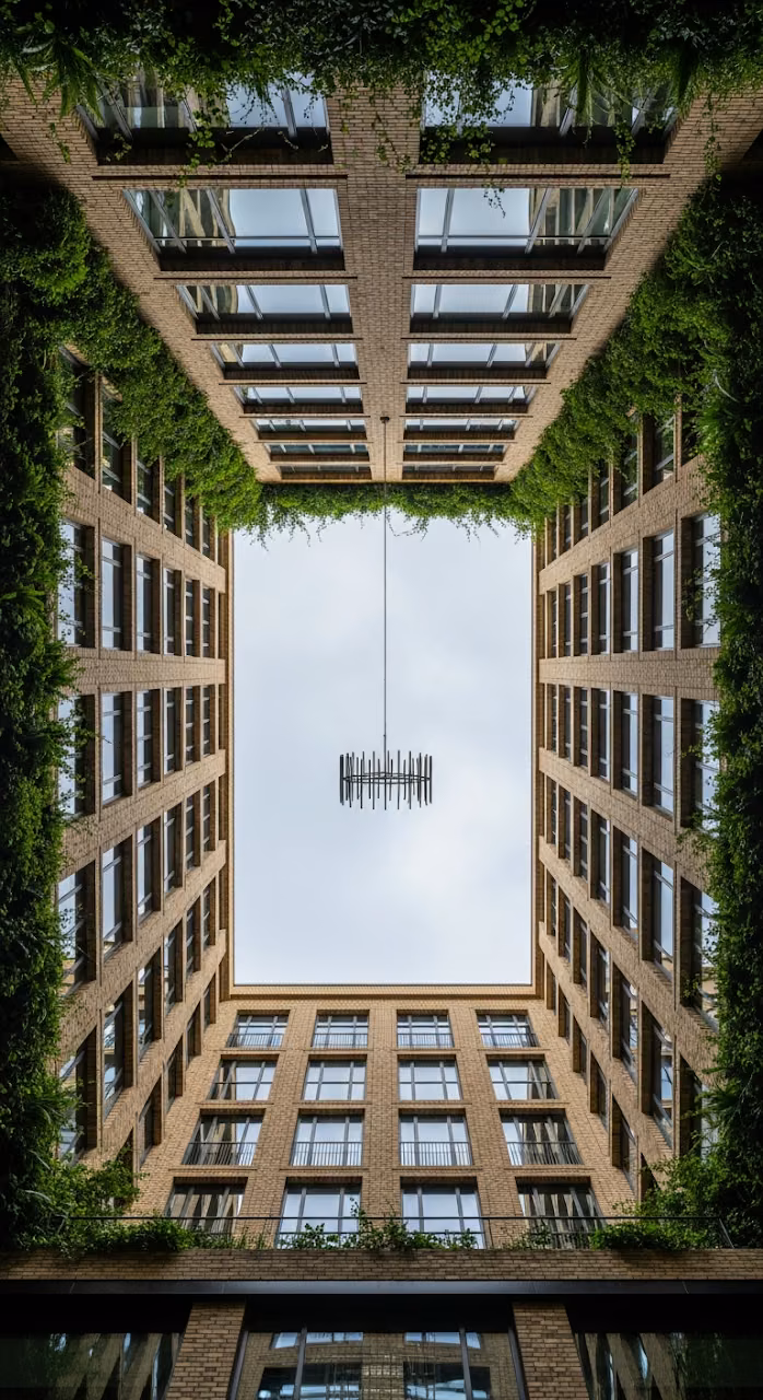 Download Symmetrical Low-Angle View of Modern Brick Architecture Forming an Urban Canyon with Hanging Foliage Wallpaper in Mobile HD Symmetrical Low-Angle View of Modern Brick Architecture Forming an Urban Canyon with Hanging Foliage - Free Mobile AMOLED Wallpaper Background