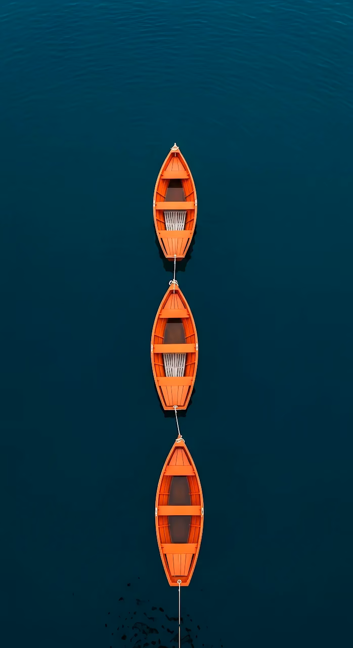 Three Orange Rowboats Moored on Deep Teal Water - Free Mobile AMOLED Wallpaper Background