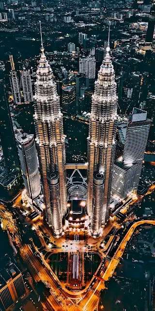 Aerial Night View of Illuminated Petronas Twin Towers - Free 4K & 8K Mobile Wallpaper