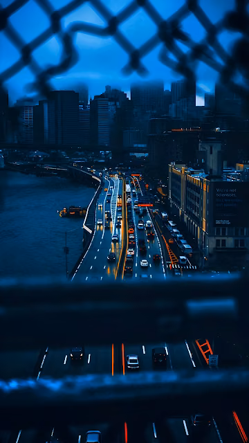 City Highway at Night Viewed Through Chain Link Fence - Free 4K & 8K Mobile Wallpaper