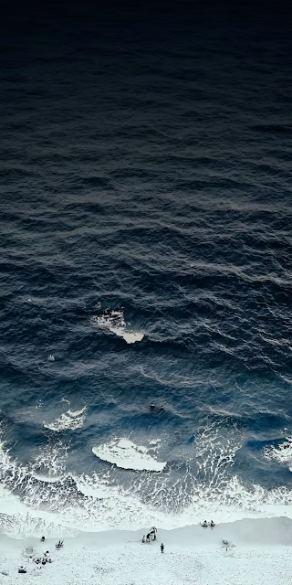 Dramatic Aerial View of Dark Blue Ocean Meeting White Sand - Free 4K & 8K Mobile Wallpaper