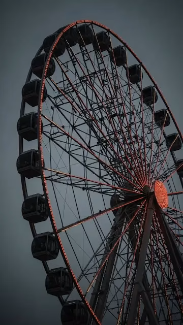 Giant Ferris Wheel with Red Lights at Dusk - Free 4K & 8K Mobile Wallpaper