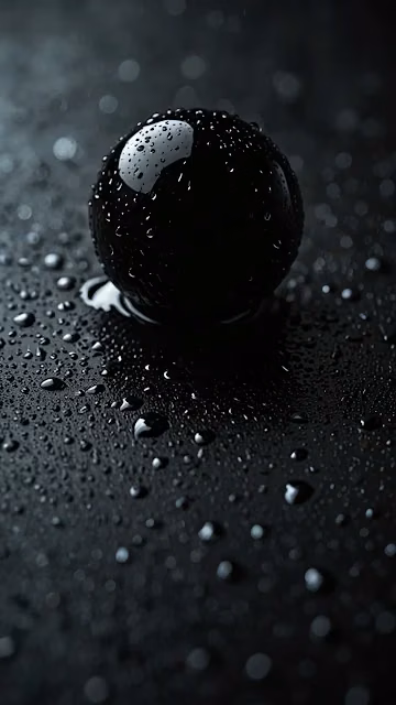 Glossy black sphere covered in water droplets on dark surface - Free 4K & 8K Mobile Wallpaper