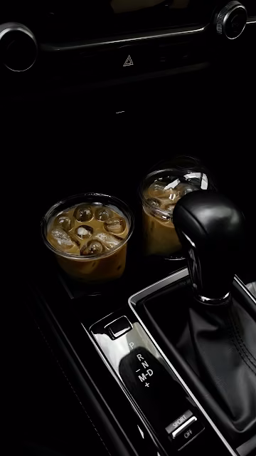 Iced Coffee Cups in Car Center Console at Night - Free 4K & 8K Mobile Wallpaper