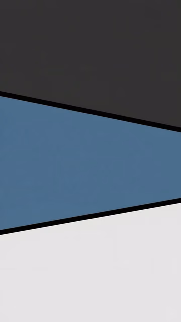 Charcoal, muted blue and pale grey geometric fields are divided by clean black diagonal bands.