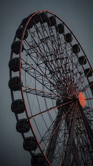 Moody Ferris Wheel with Red Lights Against Dark Sky - Free 4K & 8K Mobile Wallpaper