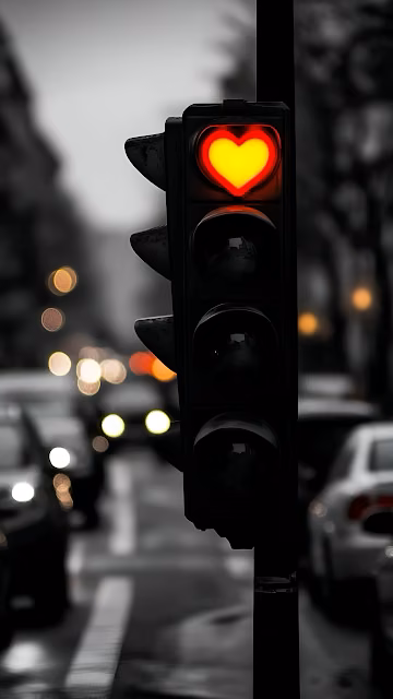 Red Heart Traffic Light Glows on Rainy City Street - Free 4K & 8K Mobile Wallpaper