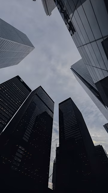 Skyscrapers Framing Cloudy Sky from Street View - Free 4K & 8K Mobile Wallpaper