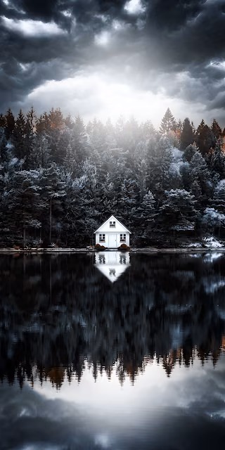 Solitary White Cabin Reflected in Dark Lake Under Stormy Sky - Free 4K & 8K Mobile Wallpaper