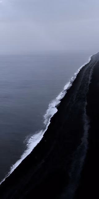 Stark Black Sand Beach and Moody Ocean Coastline View - Free 4K & 8K Mobile Wallpaper