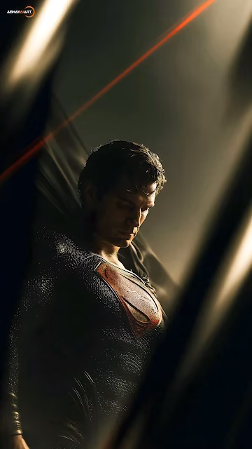 Superman in a black suit bows his head beneath a single beam of cinematic golden sunlight. Superman in black suit looking down in dramatic shadow under a diagonal beam of sunlight.