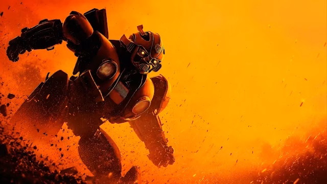 Autobot Bumblebee charging forward aggressively through flying rocky debris against an intense golden orange background.