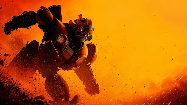 Bumblebee charges forward through intense golden dust and fiery sparks with glowing yellow optics. Autobot Bumblebee charging forward aggressively through flying rocky debris against an intense golden orange background.