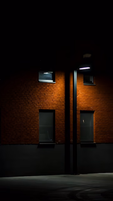 Urban Night Scene Red Brick Wall Illuminated by Streetlight - Free 4K & 8K Mobile Wallpaper