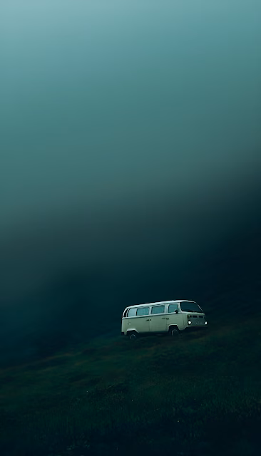 Vintage VW Bus on Moody Emerald Hillside in Deep Fog - Free 4K & 8K Mobile Wallpaper